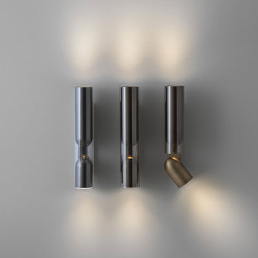Penta Clash wall sconce, studio view of the glass and metal lamp