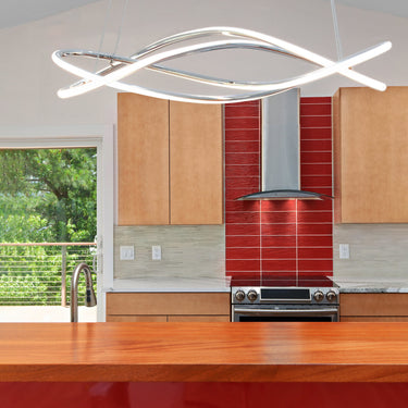 ET2 Coaster twisted channel LED pendant in polished chrome hanging from a vaulted ceiling above a wood-and-red kitchen island