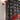 Oluce Colombo wall lamp in scarlet red mounted on a wall in a styled room
