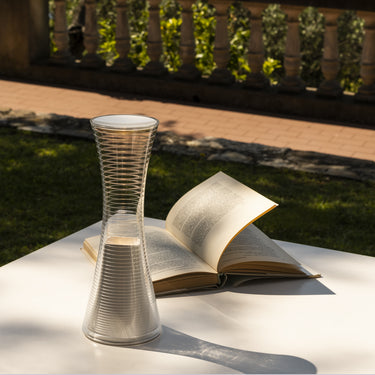 Minimalist rechargeable LED lamp with transparent prismatic body for task lighting