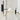 Detail of Crosby wall light frame, glossy black with natural brass accents.