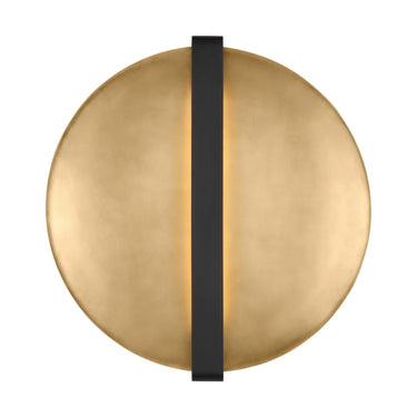 Photo of Cymbal LED wall sconce, 2700K warm white light, mounted vertically in a living room.