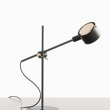 Modern adjustable desk lamp G.O. by Oluce with satin gold accents and black bas
