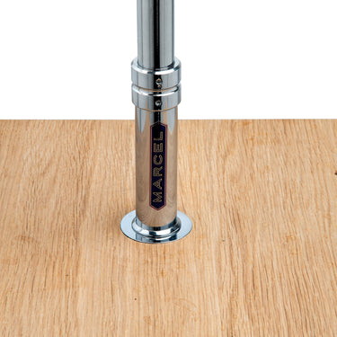 Close-up of the Marcel badge on the chromed fork in solid oak