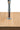 Close-up of the Marcel badge on the chromed fork in solid oak