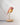 Daqiconcept Bird LED Dimmable Table Lamp - Burnt Brick BR01BBL illuminating a book on a bedside table