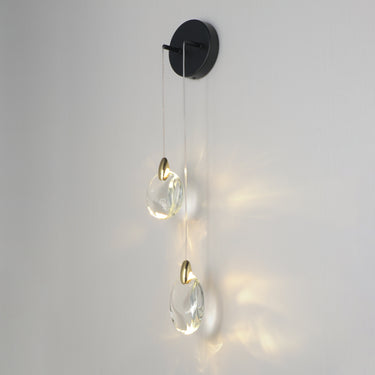 ET2 Pebble Black / Polished Gold wall sconce, alternate angle of the two hanging crystal pebbles