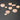 ET2 Nimbus 10-light pendant, lit glass shades of several sizes against a dark gray wall