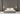 ET2 Revolver rotating halo wall sconce, two round white discs mounted either side of a bed on a dark gray bedroom wall