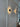 ET2 Saucer gold disc wall sconce, two glowing discs on a white paneled wall beside a window