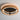 ET2 Kaia in Antique Bronze mounted flat on a light ceiling with a warm glow around the ring