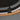 Close-up of the Kaia Antique Bronze bracket joining the lit inner ring to the rattan band