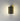 ET2 Omni Black wall sconce lit on a gray wall, light spilling up and down
