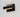 ET2 Omni Black wall sconce, three-quarter view of the glowing light bar