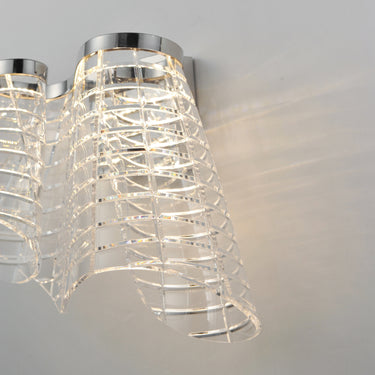 ET2 Tartan etched acrylic wall sconce, Polished Chrome, lit, close side view of the etched acrylic