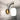 ET2 Soji lantern glass wall sconce with black arm and brass trim on a gray crackle-tile wall, close-up