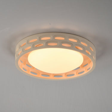 ET2 Cambria 13 in flush mount lit, warm light glowing through the oval cutouts on a gray ceiling