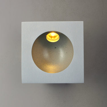 ET2 Alumilux Step Light low voltage outdoor wall light, Satin Aluminum, lit with warm light inside the round recess