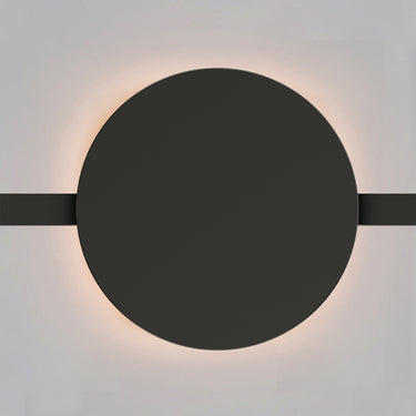 ET2 Continuum Wall Washer track light, Round, black round disc glowing with a warm halo on a gray wall