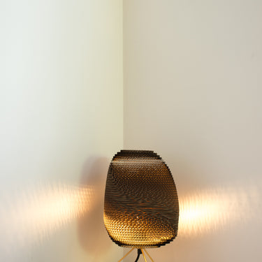 Modern desk lamp with brass frame and natural cardboard shade