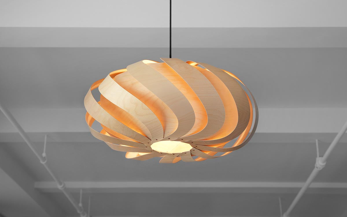 Wooden Eclipse Pendant Light in Hotel Setting: Sophisticated Charm