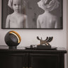 Eva LED table lamp by Oluce in black metal with gold interior, modern indirect lighting design for bedroom bedside table