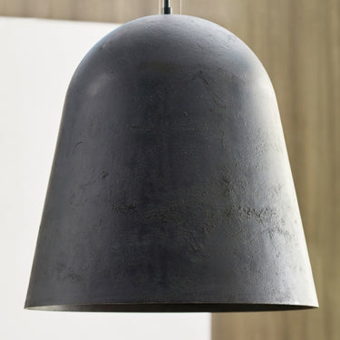 Industrial-style bell pendant light, deep weathered zinc texture, restaurant.
