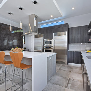 ET2 Fizz III bubble glass cube pendants in a modern kitchen with a white island and orange barstools