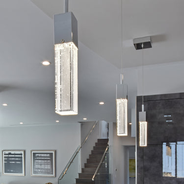 ET2 Fizz III tall bubble glass pendants hanging in a two-story stairwell with a glass stair rail