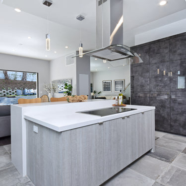 ET2 Fizz III mini pendants over a gray kitchen island that opens to a living room