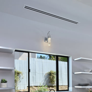 ET2 Fizz III bubble glass wall sconce mounted on a white kitchen wall above a window with open shelves