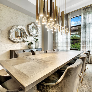 ET2 Flute brass tubes over a long pale dining table with sheer curtained windows behind