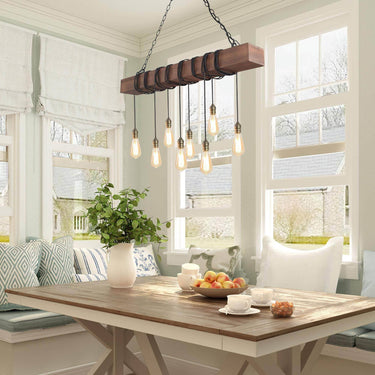 rustic 8 light wood and black metal linear chandelier hanging over long dining table