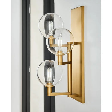 Visual Comfort Gambit Triple Wall Sconce mounted vertically with dimmable LED lighting