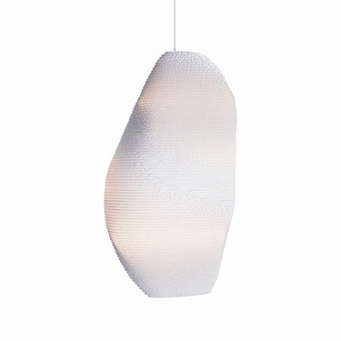 Handcrafted Graypants Denny Scraplight pendant adding organic style to a living room corner.