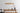 Graypants Scraplights LED Linear Pendant - Disc Shape, Cardboard, Blonde on top of dining table