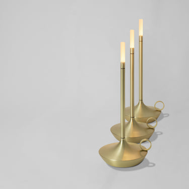 Rechargeable Wick GP204 table lamp by Graypants, casting soft light on an outdoor patio.