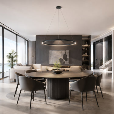 ET2 Groove 5CCT black LED ring pendant hanging over a round dining table in an open-plan room with waterfront windows