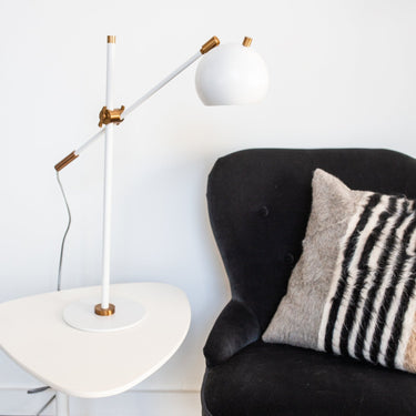 Orwell LED Counterbalance Table Lamp in White with Weathered Brass Accents styled in a lived-in room – House of Troy #2