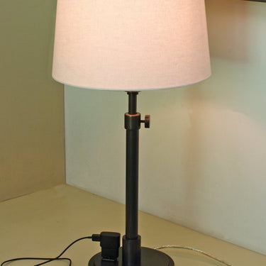 Townhouse Adjustable Table Lamp with Outlet styled in a lived-in room – House of Troy