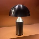 Satin black nickel Atollo table lamp by Vico Magistretti for bedside and office desk use