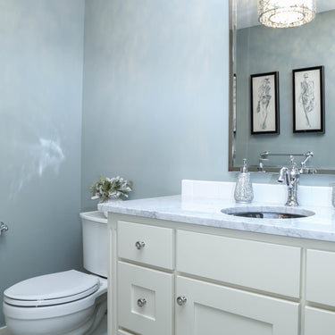 ET2 Inca flush mount reflected in a mirror above a white vanity in a bathroom