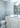 ET2 Inca flush mount reflected in a mirror above a white vanity in a bathroom