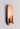 Luxurious copper Innermost Brixton wall fixture, casting indirect light in a contemporary living room space.