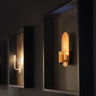 Vertical copper Innermost Brixton industrial wall lamp, providing warm up-lighting for narrow corridors.