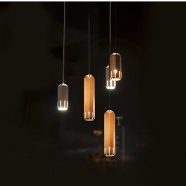 Industrial style Innermost Brixton dimmable LED fixture (5W 120V), providing focused light for a reading nook.