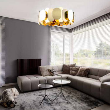 Brass finish Panel 75 designer chandelier hanging above living room