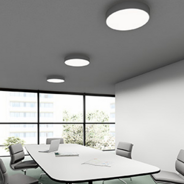 Dimmable flush mount ceiling light with integrated LED in matte white in conference room setting