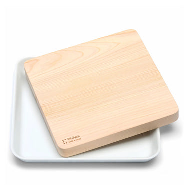 Hinoki board resting on the white porcelain plate · Sitaku Cutting Board Plate, Kihara (view 1)