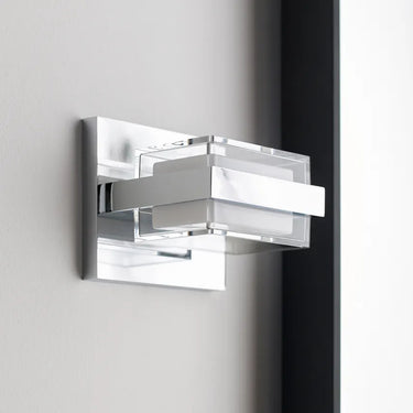 Kamden 1-Light pressed-glass bath light glowing in a spa-like bath